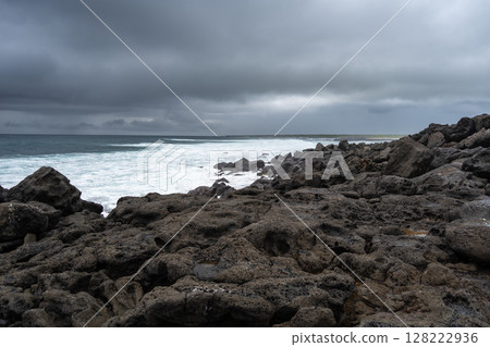 Calm seascape with rocks at Playa Loberia, San Cristobal 128222936