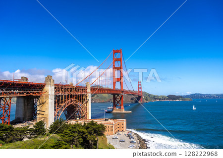 Golden Gate Bridge over blue waters with scenic hills in San Francisco Golden Gate Bridge over blue waters with scenic hills in San Francisco 128222968