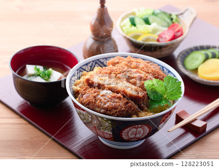 A colorful Japanese set meal with pork cutlet rice bowl, miso soup and salad A colorful Japanese set meal with pork cutlet rice bowl, miso soup and salad 128223051