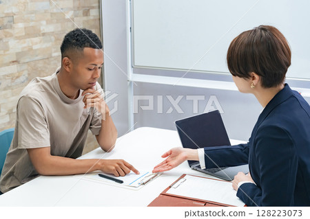 A black man and a Japanese female staff member having an interview A black man and a Japanese female staff member having an interview 128223073