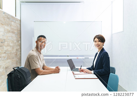 一名黑人男子和一名日本女工作人員正在接受採訪 128223077