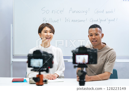 A black man and a Japanese woman filming a video A black man and a Japanese woman filming a video 128223149