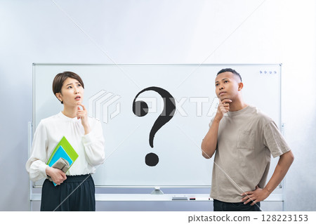 A black man and a Japanese woman thinking in front of a whiteboard with a question mark written on it A black man and a Japanese woman thinking in front of a whiteboard with a question mark written on it 128223153