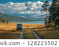 Off-road vehicle enjoying stunning lake and mountain view in autumn 128223502