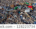 Plastic bottles and garbage polluting a pebble beach 128223734