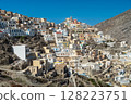 Olympos village cascading down the mountainside on karpathos island, greece, bathed in sunlight 128223751