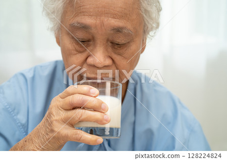 Asian elderly woman patient drinking milk food in breakfast. Asian elderly woman patient drinking milk food in breakfast. 128224824