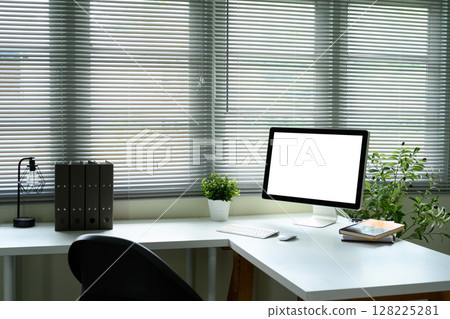 Blank monitor screen, surrounded by plants and natural light from window blinds Blank monitor screen, surrounded by plants and natural light from window blinds 128225281