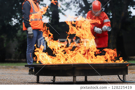 corporate safety - exercise during a firefighting course 128225419
