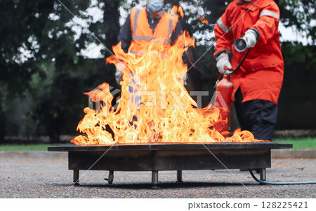corporate safety - exercise during a firefighting course 128225421