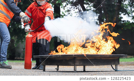 corporate safety - exercise during a firefighting course 128225423