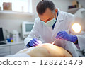 Surgeon performing a skin surgery with surgical instruments 128225479
