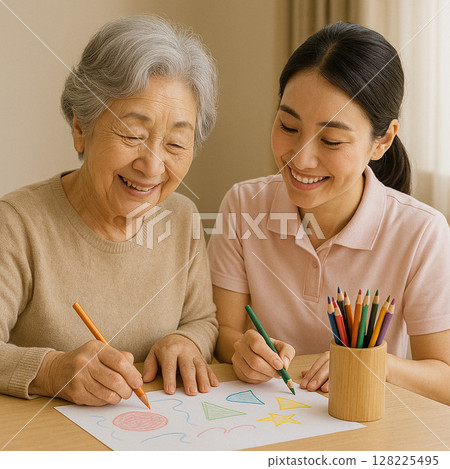 Caregiver enjoying drawing pictures with an elderly woman Caregiver enjoying drawing pictures with an elderly woman 128225495