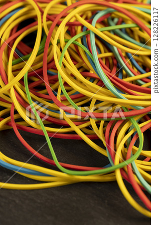a large number of multi-colored rubber bands for office or money packaging, empty scattered thin rubber bands of different colors for packaging and organizing paper money a large number of multi-colored rubber bands for office or money packaging, empty scattered thin rubber bands of different colors for packaging and organizing paper money 128226117