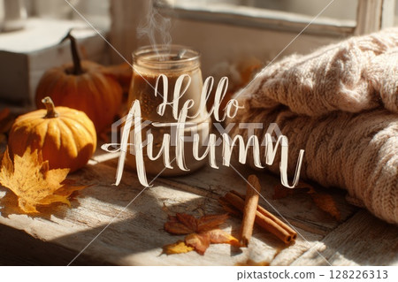 autumn banner with text hello autumn, cup of hot drink on wooden window sill, pimpkins and fallen leaves 128226313