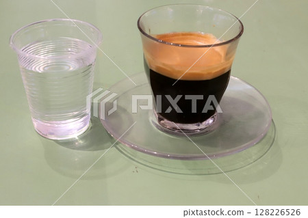 There is hot black coffee in a glass There is hot black coffee in a glass 128226526