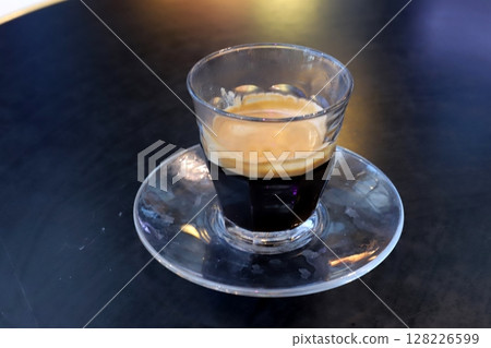There is hot black coffee in a glass There is hot black coffee in a glass 128226599