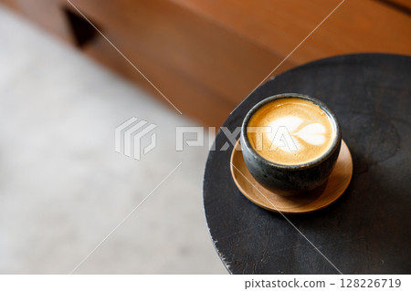 Cup of milk latte coffee on table by the street. 128226719