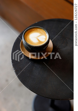 Cup of milk latte coffee on table by the street. 128226727