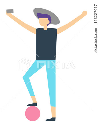 Young tourist wearing stylish summer clothes and a trendy hat, joyfully taking a selfie while balancing on a vibrant pink ball, radiating freedom and excitement during vacation 128227017