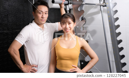Men and women in sportswear looking at each other with a smile 128227045