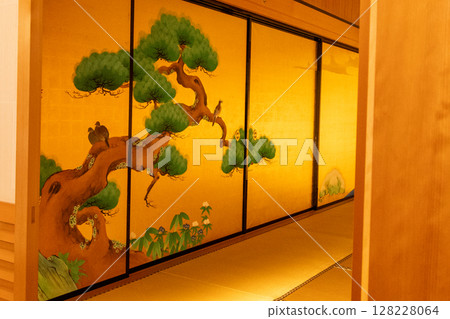 Traditional Japanese painting of pine and plum blossoms on the gold leaf sliding doors of the Nagoya Castle Honmaru Palace. Traditional Japanese painting of pine and plum blossoms on the gold leaf sliding doors of the Nagoya Castle Honmaru Palace. 128228064