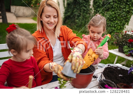 Joyful gardening moments with children in a backyard 128228481