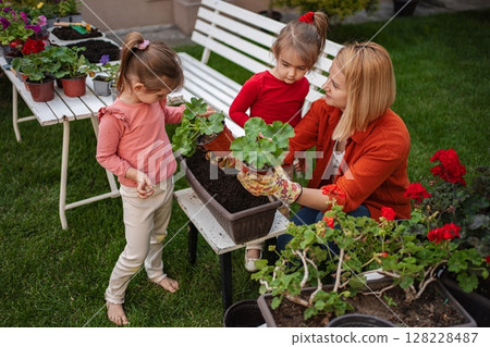 Family bonding through gardening in a sunny backyard 128228487