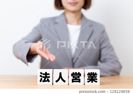 Corporate sales block and middle-aged female business woman wearing a suit Corporate sales block and middle-aged female business woman wearing a suit 128228656