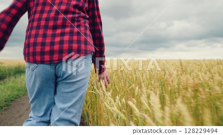 agriculture, child running for girl, Little girl touches wheat, running wild and free, endless wheat field, pasture road, simplicity of life outside, farm adventure, innocence in motion, rural stroll 128229494
