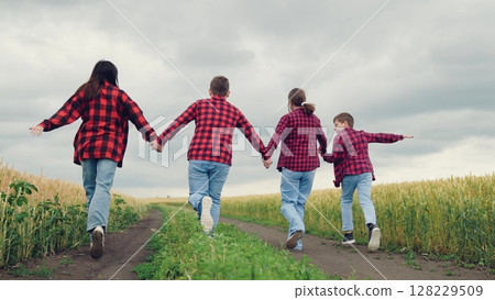 Boys and girls embrace adventure, Mom is their flying partner, Wheat field alive with joy, Country road leads to happiness, Childhood games take flight, Imagination is their superpower, Running 128229509