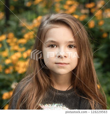 Portrait of a young girl with natural background and thoughtful expression Portrait of a young girl with natural background and thoughtful expression 128229563