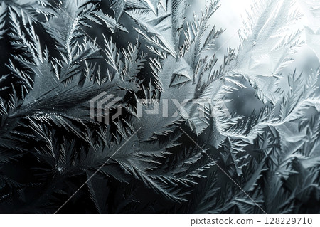 Closeup of intricate ice crystal patterns on a frosted window surface 128229710