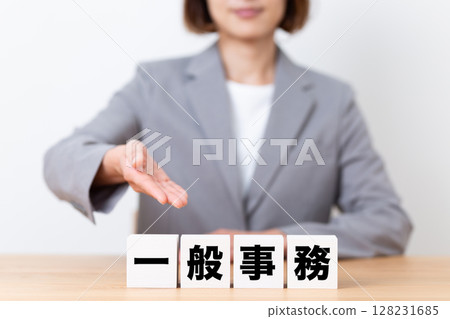 A middle-aged female business woman wearing a suit and a general office block 128231685