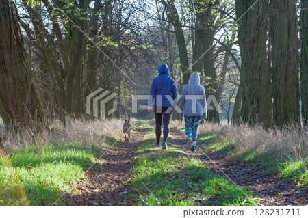 Couple Walking Dog on Forest Path 128231711