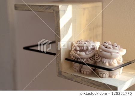A white shisa souvenir from Okinawa placed on a shelf in the entrance hall. Okinawa Yachimun 128231770