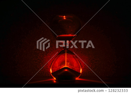 artistic glowing hourglass like sunrise or sunset, symbolizing time and creativity. Vibrant lighting against a dark minimalist backdrop. Concepts of time management, life balance, and artistic design. 128232333
