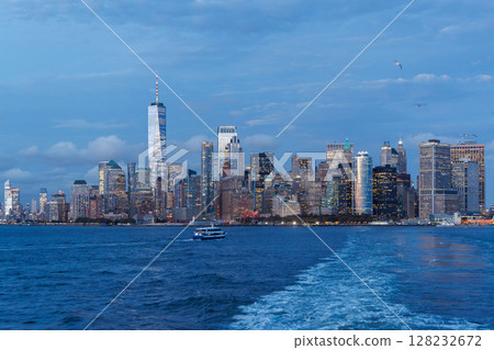A vibrant sunset panorama of Manhattan downtown skyline, viewed from the river 128232672