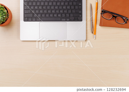 A clean and minimal desk setup featuring a laptop and notepad A clean and minimal desk setup featuring a laptop and notepad 128232694