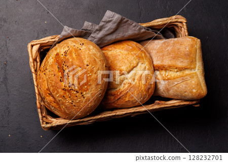 An assortment of freshly baked bread displayed on a table 128232701