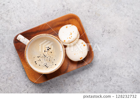 Top view of a coffee cup and macaroons Top view of a coffee cup and macaroons 128232732