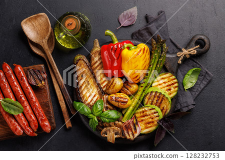 Assorted grilled vegetables including bell peppers, zucchini, eggplant, and sausages Assorted grilled vegetables including bell peppers, zucchini, eggplant, and sausages 128232753