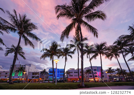 Colorful Art Deco hotels on Ocean Drive in Miami Beach glow under the warm hues of a vibrant sunset Colorful Art Deco hotels on Ocean Drive in Miami Beach glow under the warm hues of a vibrant sunset 128232774