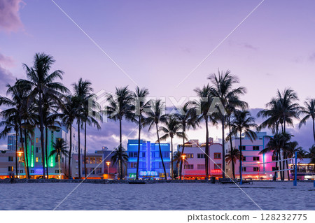 Colorful Art Deco hotels on Ocean Drive in Miami Beach glow under the warm hues of a vibrant sunset Colorful Art Deco hotels on Ocean Drive in Miami Beach glow under the warm hues of a vibrant sunset 128232775