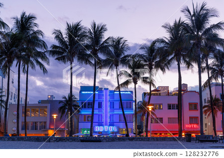Colorful Art Deco hotels on Ocean Drive in Miami Beach glow under the warm hues of a vibrant sunset Colorful Art Deco hotels on Ocean Drive in Miami Beach glow under the warm hues of a vibrant sunset 128232776