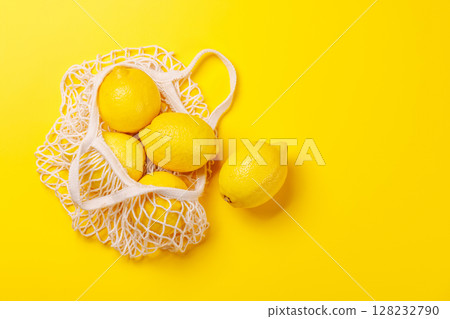 Fresh juicy lemons in a mesh bag, flat lay style 128232790
