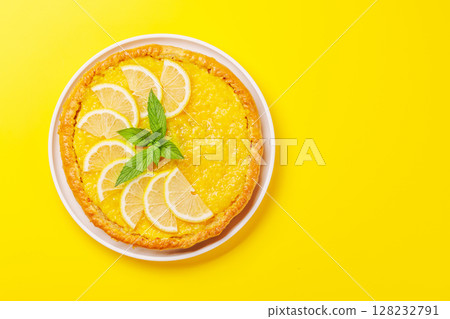 Delicious lemon tart with golden crust and smooth, glossy lemon filling 128232791