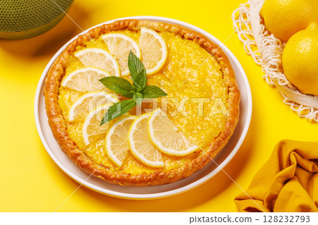 Delicious lemon tart with golden crust and smooth, glossy lemon filling 128232793
