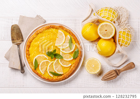 Delicious lemon tart with golden crust and smooth, glossy lemon filling 128232795