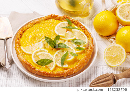 Delicious lemon tart with golden crust and smooth, glossy lemon filling 128232796